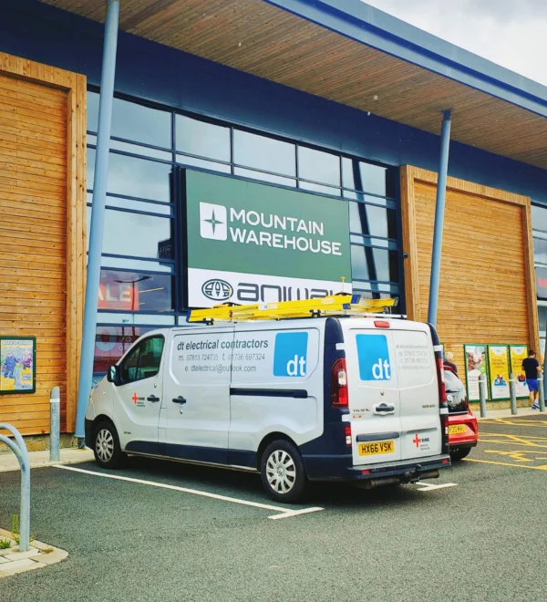 DT Electrical Contractors van outside Mountain Warehouse retail unit Cornwall